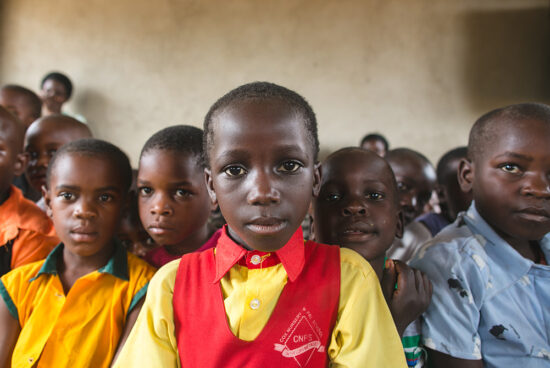 Kids from the Uganda Foster Family School looking directly into the camera