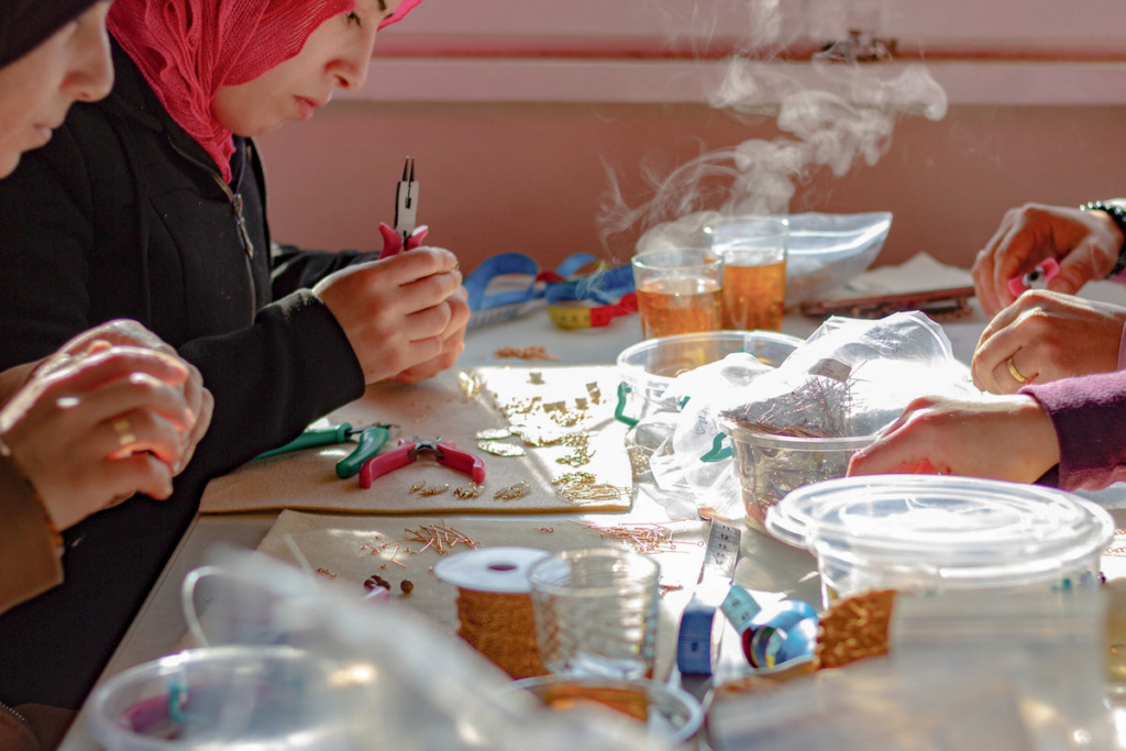 Hope's Gate women making jewelry