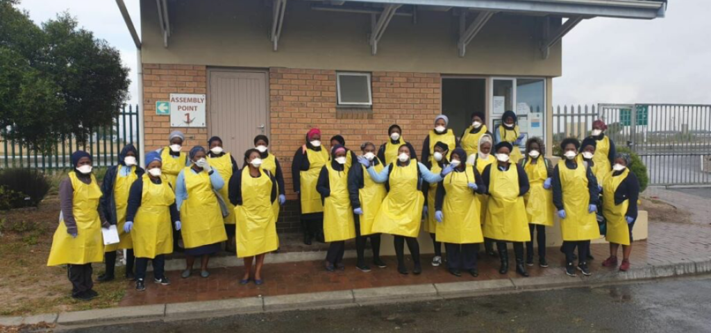 beautiful gate workers pose in front of building