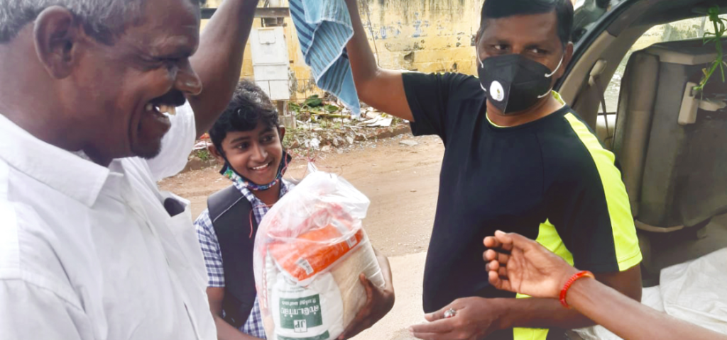 man and boy receiving food package