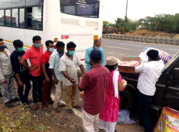 migrant workers wait for food