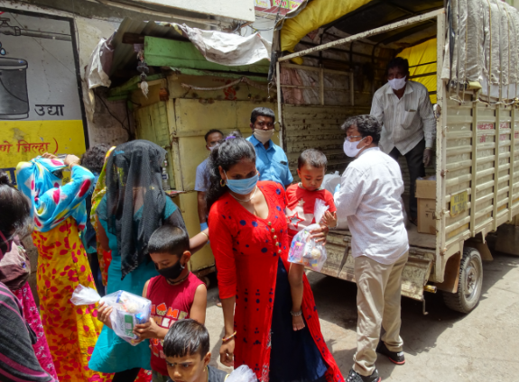 woman holding child receiving monthly food rations