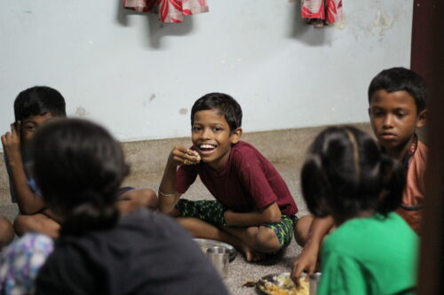 boy happy eating at day center calcutta