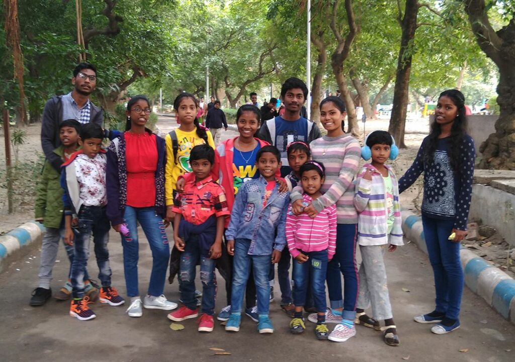 group of children smiling on streets calcutta