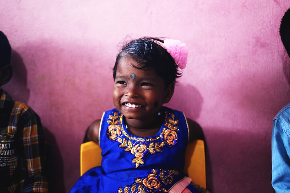 girl smiling at Irula Children's Center