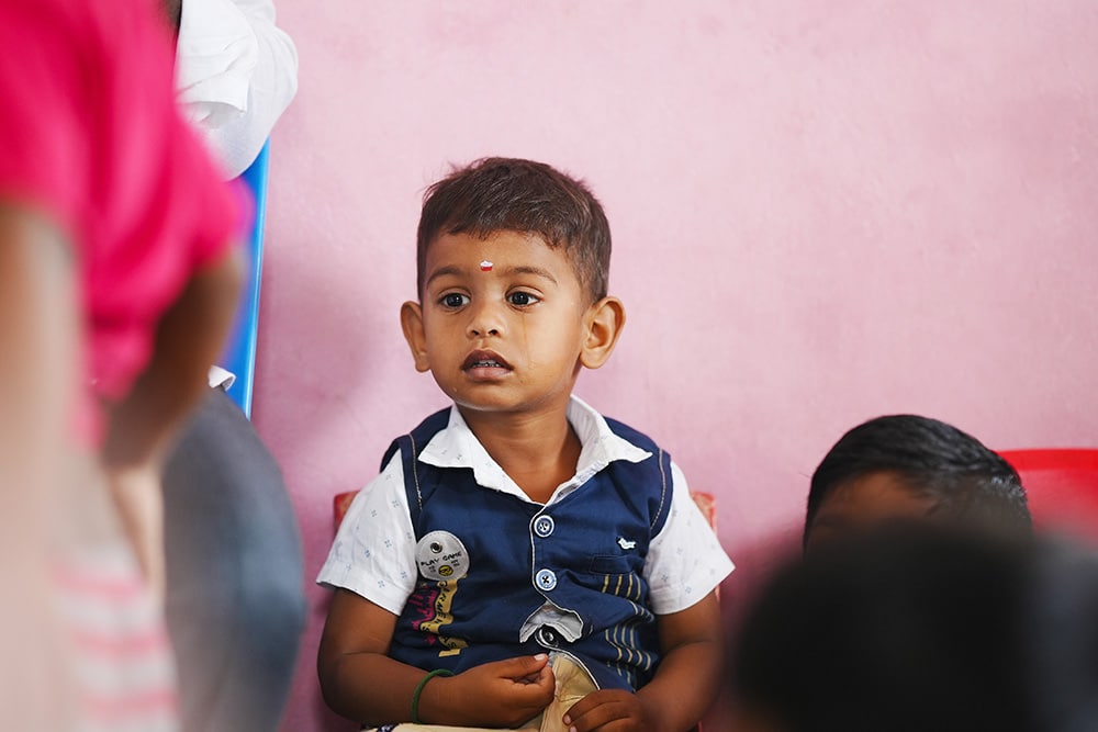 boy watching intently at Irula Children's Center