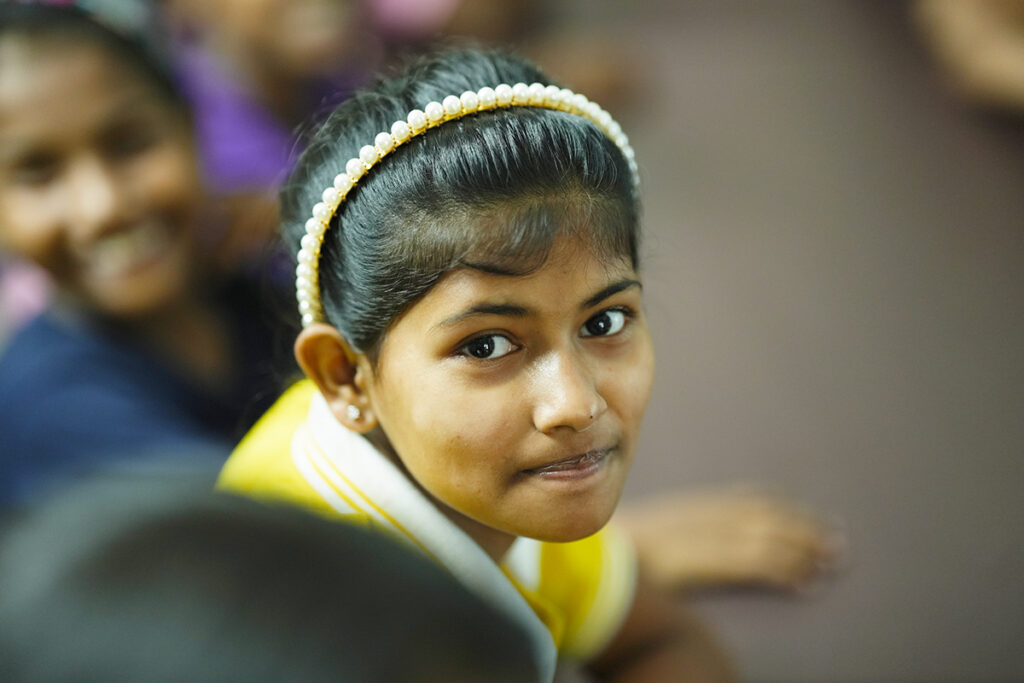 Young girl looks with hopeful eyes.