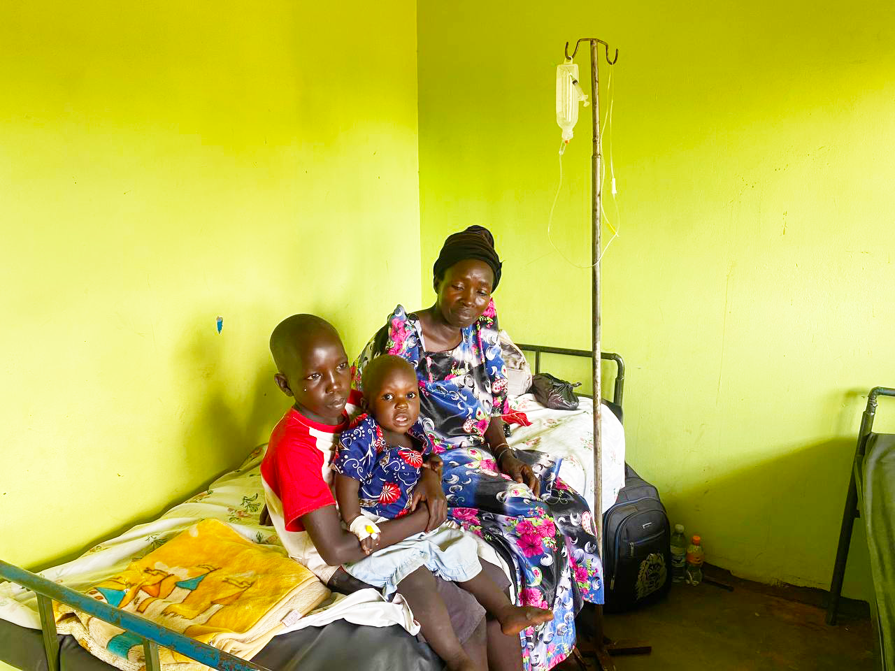 family waiting on a bed while IV meds are given