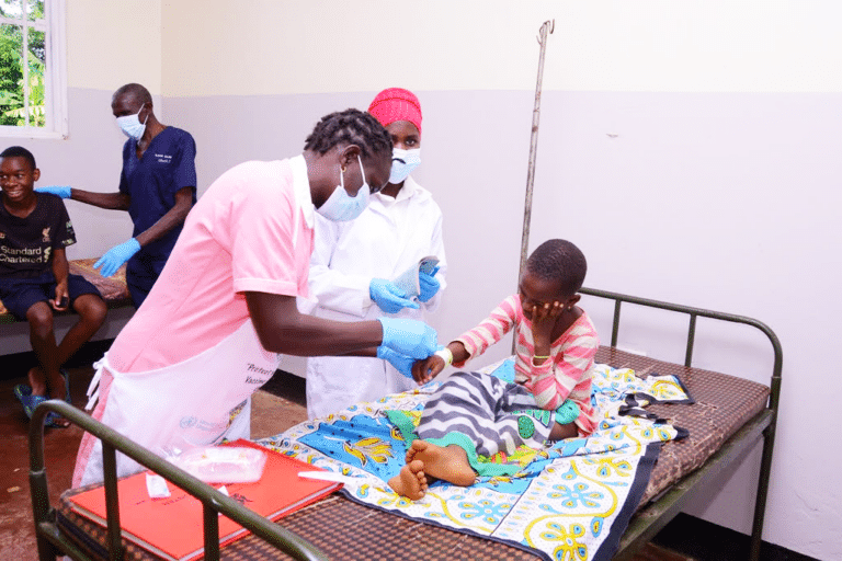 little girl getting an IV put in.