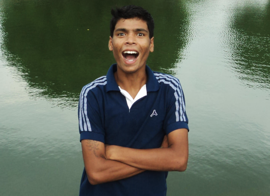 tapos as a smiling young man