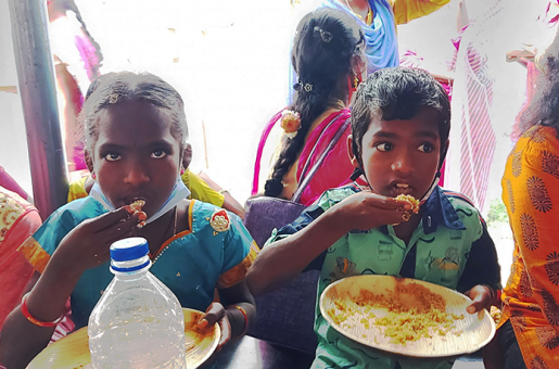 Children enjoying their meal at a Christmas program in India.