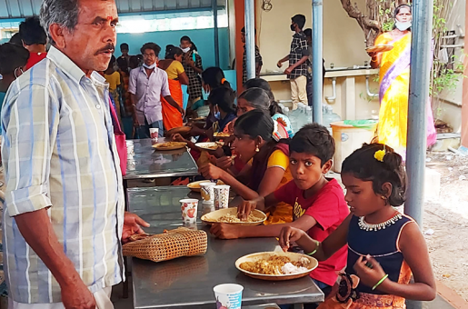 Children enjoying food at a Christmas program in India.